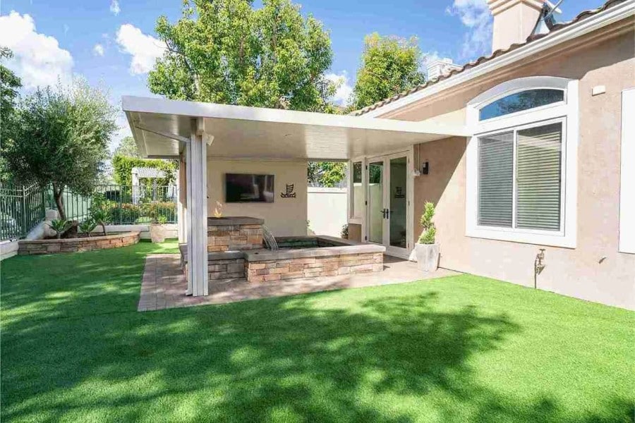backyard - exterior - grass - fan - waterfall - plants - trees - doors - windows - bells - outdoors - room - stairs - sofas - igs construction